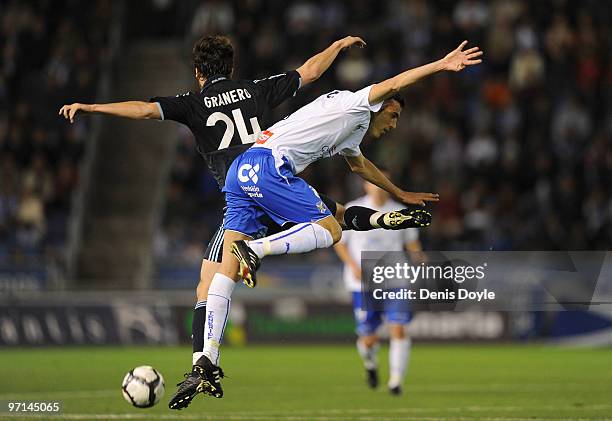 Esteban Granero of Real Madrid is tackled by Alejandro Alfaro of Tenerife during the La Liga match between Tenerife and Real Madrid at the Heliodoro...