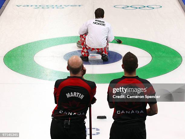 Kevin Martin and John Morris of Canada and Thomas Ulsrud of Norway looks on during the Curling Men's Gold medal game between Canada and Norway on day...