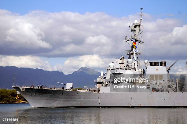 In this handout image provided by the U.S. Navy, The guided-missile destroyer USS O'Kane makes its way out of Pearl Harbor as the state of Hawaii...