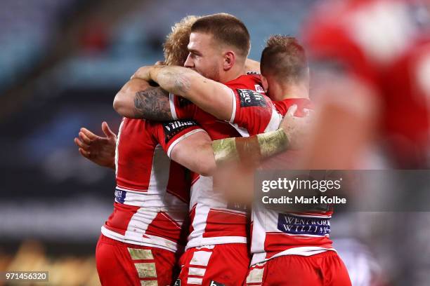 James Graham, Euan Aitken and Matt Duffy of the Dragons celebrate victory during the round 14 NRL match between the Canterbury Bulldogs and the St...