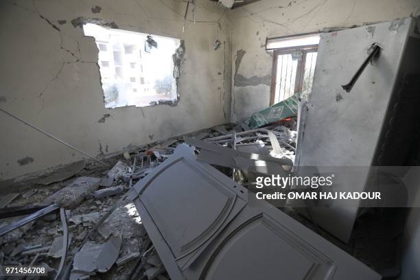 Picture taken on June 11, 2018 shows a damaged apartment following reported air strikes by pro-government forces in the town of Binnish in Syria's...