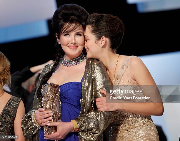 President of the ceremony actress Marion Cotillard congratulates Actress Isabelle Adjani for being awarded best Actress 2010 after the show at the...