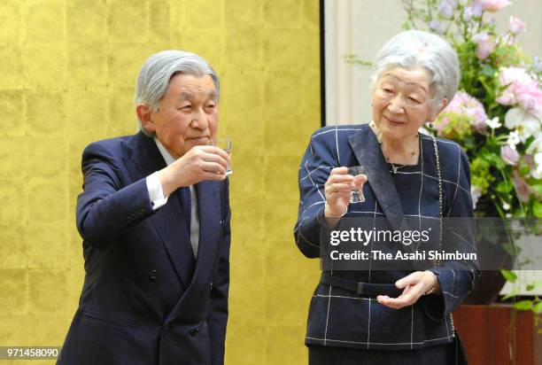 Emperor Akihito and Empress Michiko toast glasses during the reception of the National Tree Planting Festival at Spa Resort Hawaiians on June 9, 2018...