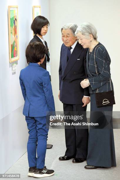 Emperor Akihito and Empress Michiko talk with laureates of the National Tree-Planting festival drawing contest at Spa Resort Hawaiians on June 9,...