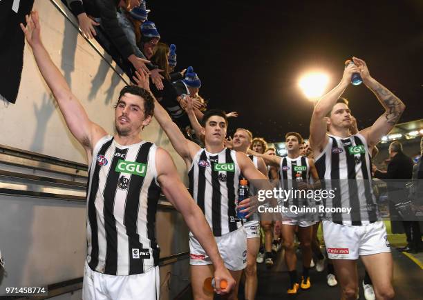 Scott Pendlebury of the Magpies high fives fans after winning the round 12 AFL match between the Melbourne Demons and the Collingwood Magpies at...