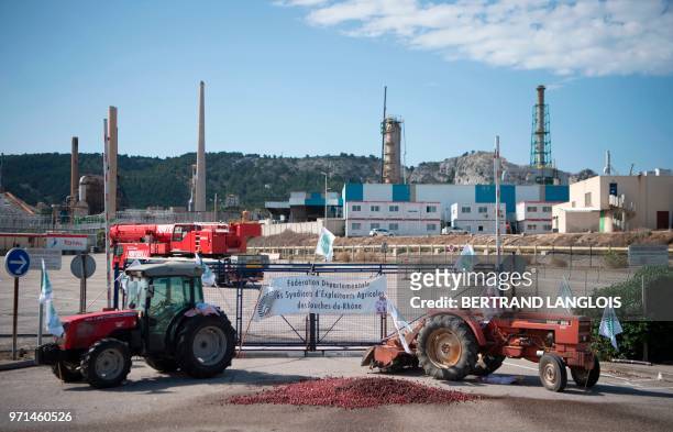 Picture taken in Chateauneuf-les-Martigues, southern France, on June 11, 2018 shows tractors blocking the access of French oil giant Total's La Mede...