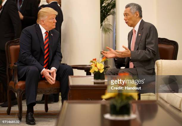 In this handout provided by the Singapore's Ministry of Communications and Information shows U.S. President Donald Trump with Singapore's Prime...