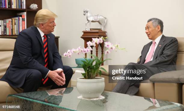 In this handout provided by the Singapore's Ministry of Communications and Information shows U.S. President Donald Trump with Singapore's Prime...