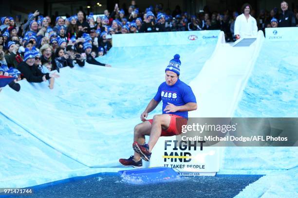 Bulldogs head coach Luke Beveridge goes down the MND slide during the round seven AFL match between the Western Bulldogs and the Gold Coast Suns at...