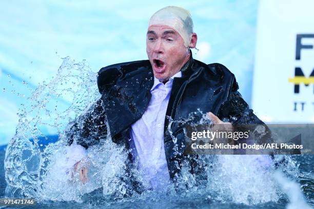 Saints head coach Alan Richardson goes down the MND slide during the round seven AFL match between the Western Bulldogs and the Gold Coast Suns at...