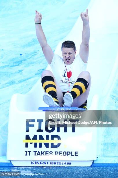 Tigers head coach Damien Hardwick goes down the MND slide during the round seven AFL match between the Western Bulldogs and the Gold Coast Suns at...