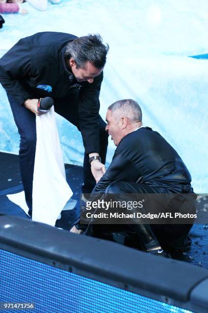Lions head coach Chris Fagan falls after he goes down the MND slide during the round seven AFL match between the Western Bulldogs and the Gold Coast...