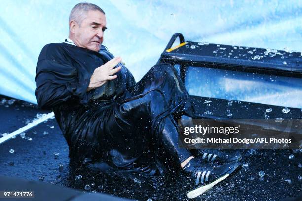 Lions head coach Chris Fagan falls after he goes down the MND slide during the round seven AFL match between the Western Bulldogs and the Gold Coast...