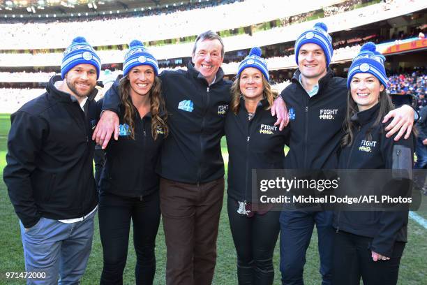 Neale Daniher is flanked by his family during the round seven AFL match between the Western Bulldogs and the Gold Coast Suns at Mars Stadium on May...