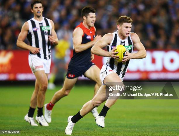Taylor Adams of the Magpies runs with the ball during the round seven AFL match between the Western Bulldogs and the Gold Coast Suns at Mars Stadium...