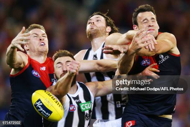 Tom McDonald of the Demons Lynden Dunn of the Magpies ,Matthew Scharenberg of the Magpies and Cameron Pedersen of the Demons compete for the ball...