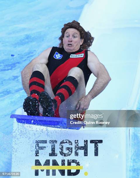 Bombers head coach John Worsfold goes down the Freeze MND slide during the round 12 AFL match between the Melbourne Demons and the Collingwood...