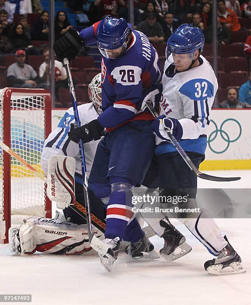 Michal Handzus of Slovakia fights for position against Toni Lydman of Finland during the ice hockey men's bronze medal game between Finland and...