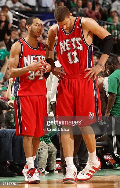 Devin Harris of the New Jersey Nets talks with Brook Lopez during a time out against the Boston Celtics at the TD Garden on February 27, 2010 in...