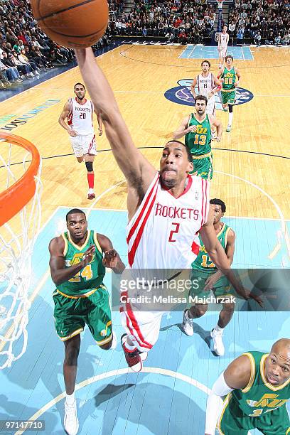 Garrett Temple of the Houston Rockets goes up for the shot against Sundiata Gaines and Paul Millsap of the Utah Jazz at EnergySolutions Arena on...
