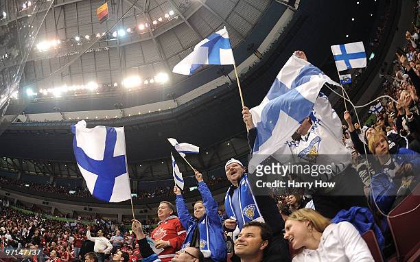 Fans of Finland wave flags during the ice hockey men's bronze medal game between Finland and Slovakia on day 16 of the Vancouver 2010 Winter Olympics...
