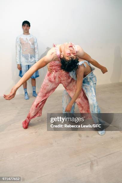 Models pose at the Ka Wa Key DiscoveryLAB during London Fashion Week Men's June 2018 at the BFC Show Space on June 11, 2018 in London, England.