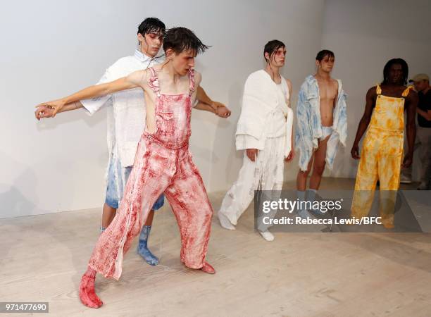 Models pose at the Ka Wa Key DiscoveryLAB during London Fashion Week Men's June 2018 at the BFC Show Space on June 11, 2018 in London, England.