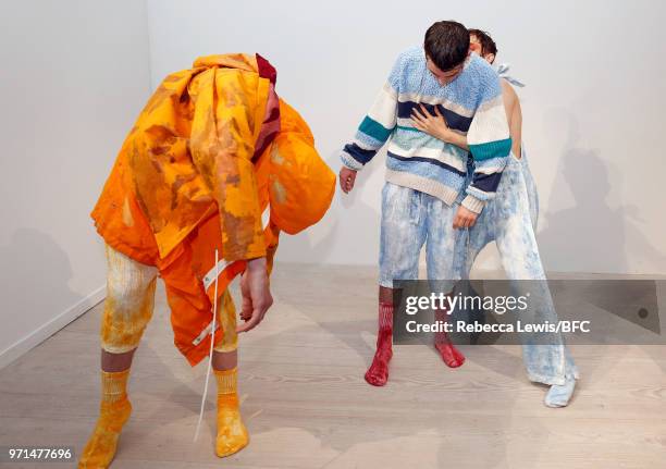 Models pose at the Ka Wa Key DiscoveryLAB during London Fashion Week Men's June 2018 at the BFC Show Space on June 11, 2018 in London, England.