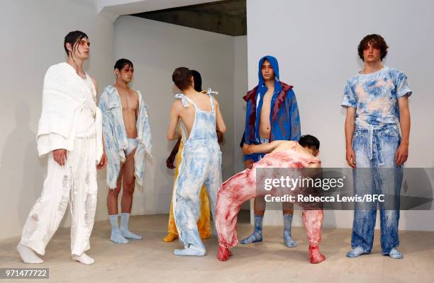 Models pose at the Ka Wa Key DiscoveryLAB during London Fashion Week Men's June 2018 at the BFC Show Space on June 11, 2018 in London, England.