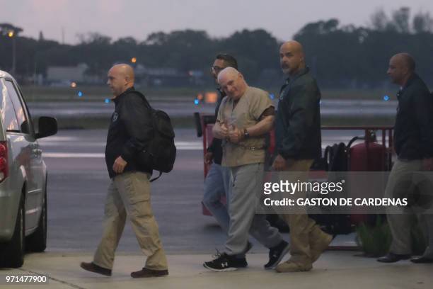Former Panamanian president Ricardo Martinelli is escorted by US Marshals to an awaiting jet early morning June 11, 2018 at Opa Locka airport near...