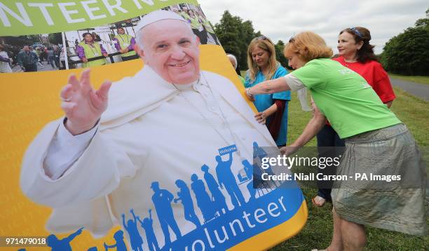 Volunteers disassemble a backdrop after a press conference at Maynooth University in Co Kildare outlining plans for Pope Francis' visit to Ireland...