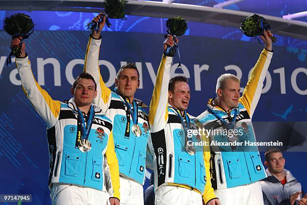 Team Germany celebrates their Silver medal during the medal ceremony for the Men's Four-Man Bobsleigh on day 16 of the Vancouver 2010 Winter Olympics...