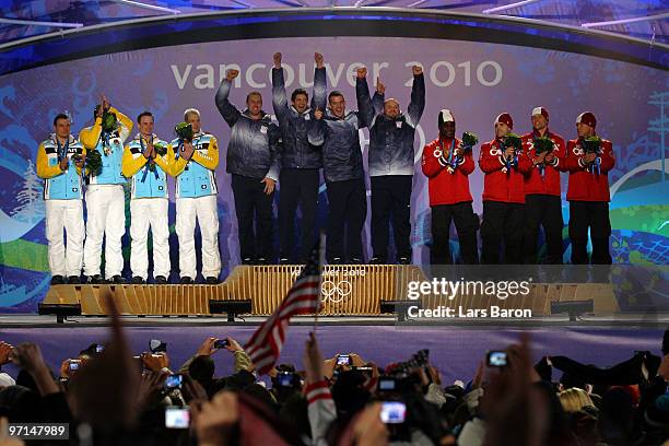 Team Germany celebrates their Silver medal, Team USA Gold and Team Canada Bronze during the medal ceremony for the Men's Four-Man Bobsleigh on day 16...