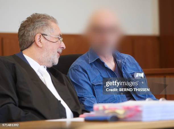 Year-old defendant Werner S sits next to his lawyer Michael Asshauer prior to his trial in the district court in Hagen, western Germany on June 11,...