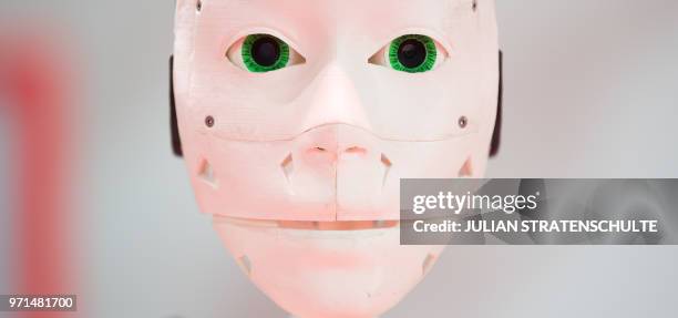 Robot face printed on 3D printer is on display at the Vodafone stand at the Cebit technology fair in Hanover on June 11, 2018. - The Digital Business...