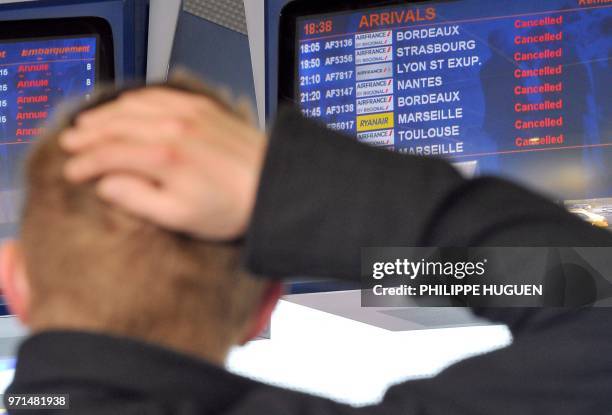 Person looks at an information board, on April 15, 2010 at Airport Lille-Lesquin, northern France closed as a result of the volcano eruption in...