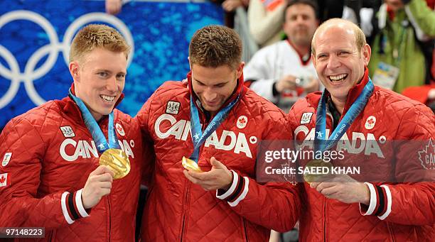 Canada's skip Kevin Martin along with teammates Marc Kennedy and John Morris celebrate on the podium during the medals ceremony after the Vancouver...