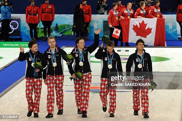 Norway's silver medalists celebrate after the medals ceremony after the Vancouver Winter Olympics men's curling final match at the Vancouver Olympic...