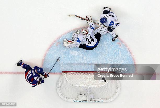 Marian Hossa of Slovakia scores a goal past Miikka Kiprusoff of Finland in the second period during the ice hockey men's bronze medal game between...