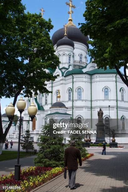 People walk past the Annunciation Orthodox Cathedral in the Russian city of Voronezh on June 11 three days ahead of the Russia 2018 World Cup...