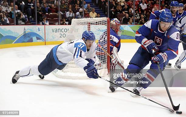 Jarkko Ruutu of Finland challeges Marian Hossa of Slovakia during the ice hockey men's bronze medal game between Finland and Slovakia on day 16 of...