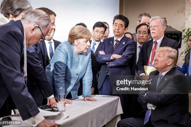 In this photo provided by the German Government Press Office , German Chancellor Angela Merkel deliberates with US president Donald Trump on the...