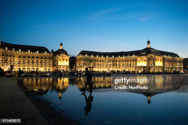 Night view of the place de de La Bourse in Bordeaux with its reflection in the so-called &quot;mirror of water&quot; considered the biggest mirror of...