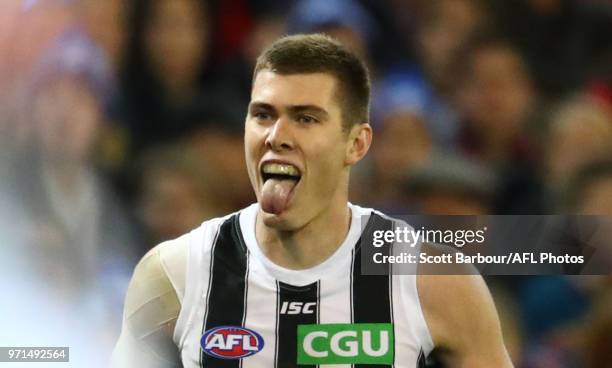 Mason Cox of the Magpies celebrates after kicking a goal during the round 12 AFL match between the Melbourne Demons and the Collingwood Magpies at...
