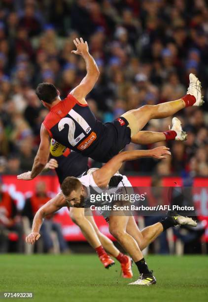 Cameron Pedersen of the Demons and Lynden Dunn of the Magpies compete for the ball during the round 12 AFL match between the Melbourne Demons and the...