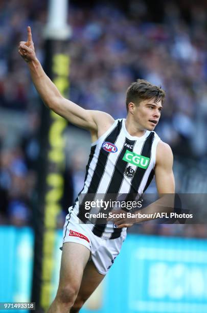 Josh Thomas of the Magpies celebrates after kicking a goal during the round 12 AFL match between the Melbourne Demons and the Collingwood Magpies at...