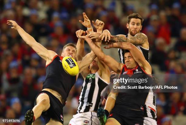 Jeremy Howe of the Magpies and Cameron Pedersen of the Demons compete for the ball during the round 12 AFL match between the Melbourne Demons and the...