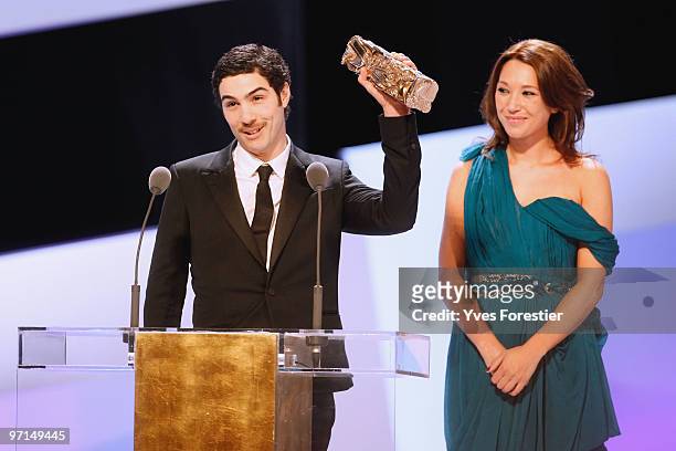 Tahar Rahim reacts on stage after he received best revelation award from Laura Smet during the 35th Cesar Film Awards at the Theatre du Chatelet on...