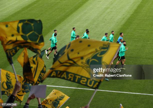 Fans wave flags in support as the Australia team warm up, during an Australian Socceroos training session ahead of the FIFA World Cup 2018 in Russia...