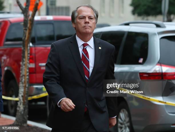 James Wolfe, former director of security for the Senate Intelligence Committee walks in to the Washington FBI Field Office to be processed on June...